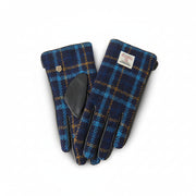 Navy tartan Harris Tweed glove gripping walking stick on Scottish hillside