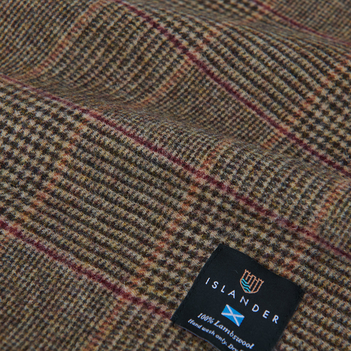 Close up of the beige dogtooth weave with a fine rust over-check