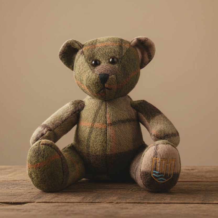 Lambswool teddy in chestnut tartan by fireplace lifestyle setting.