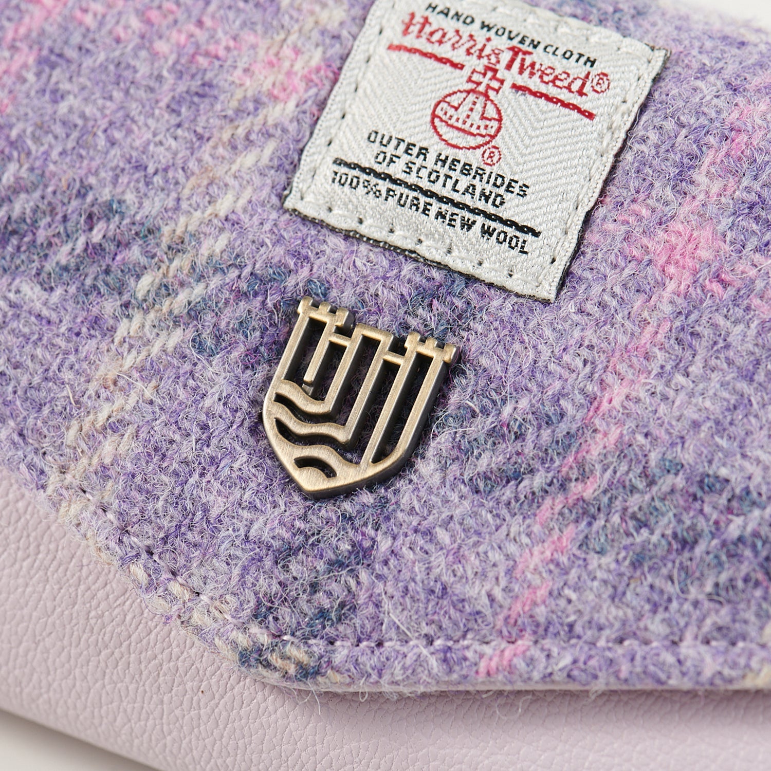 Close up of the Harris Tweed orb label and brass Islander badge