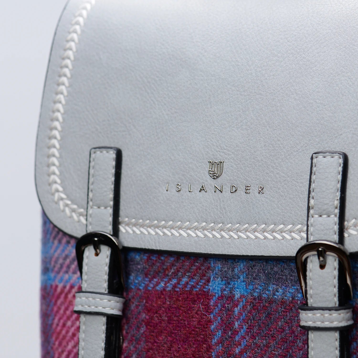 Close-up of Islander logo and braided stitching on mini backpack flap