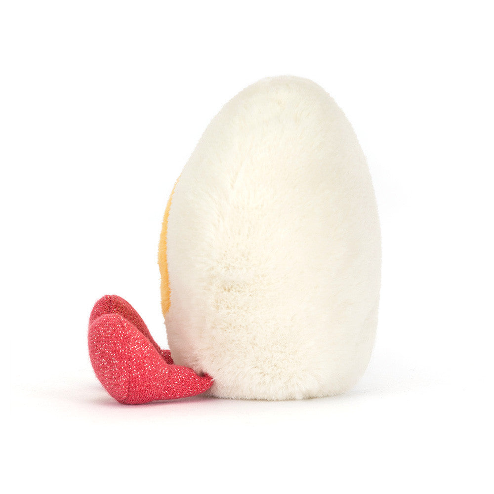 Side view of the Jellycat Heart Boiled Egg showing its sparkly pink feet