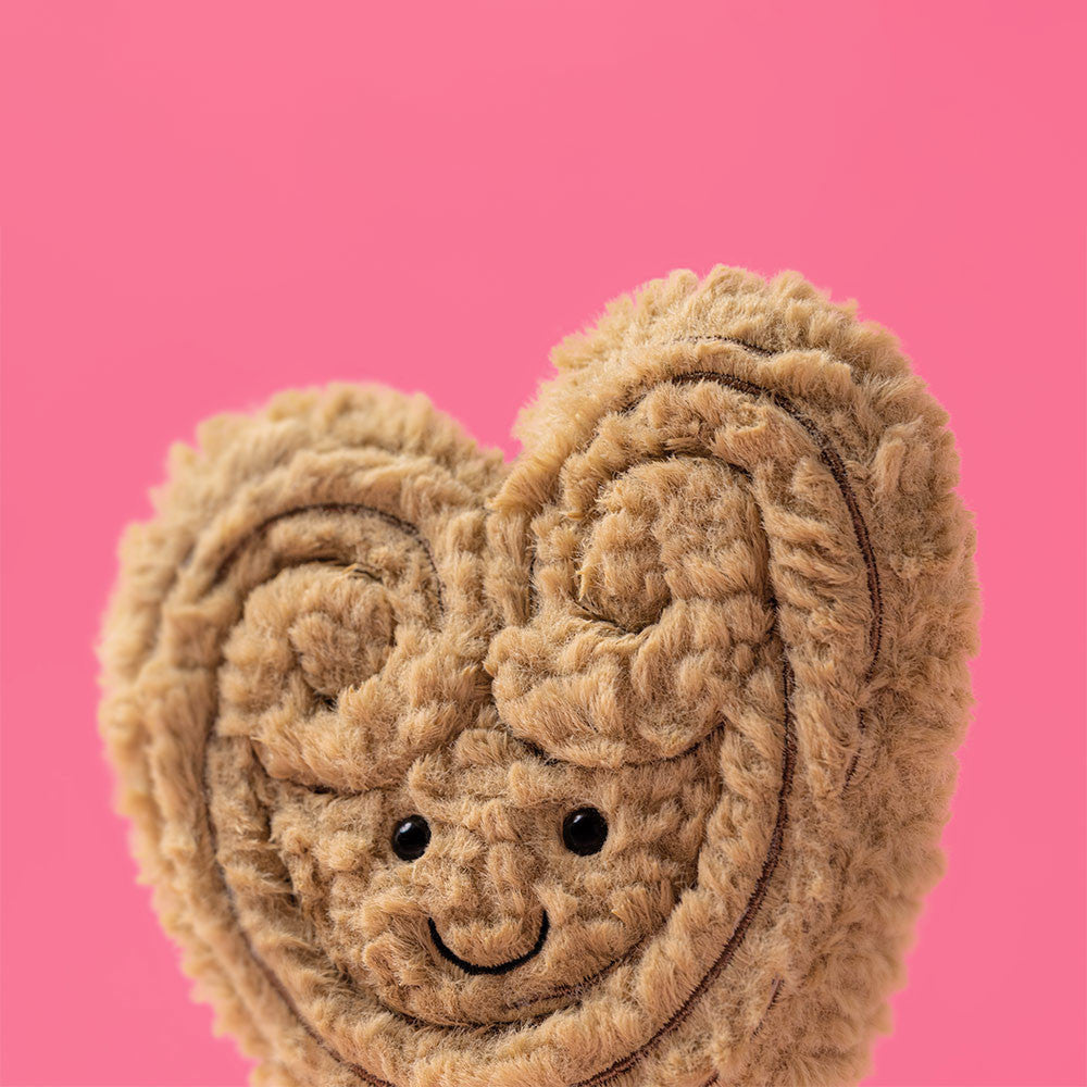 Close-up of Philippe Palmier's curly swirled pastry fur on a pink background