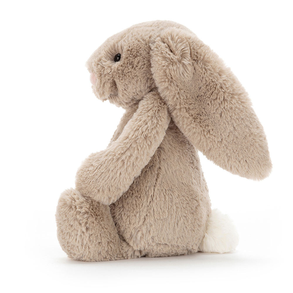 Side view of the beige Jellycat Bashful Bunny Original showing its long ears and fluffy tail