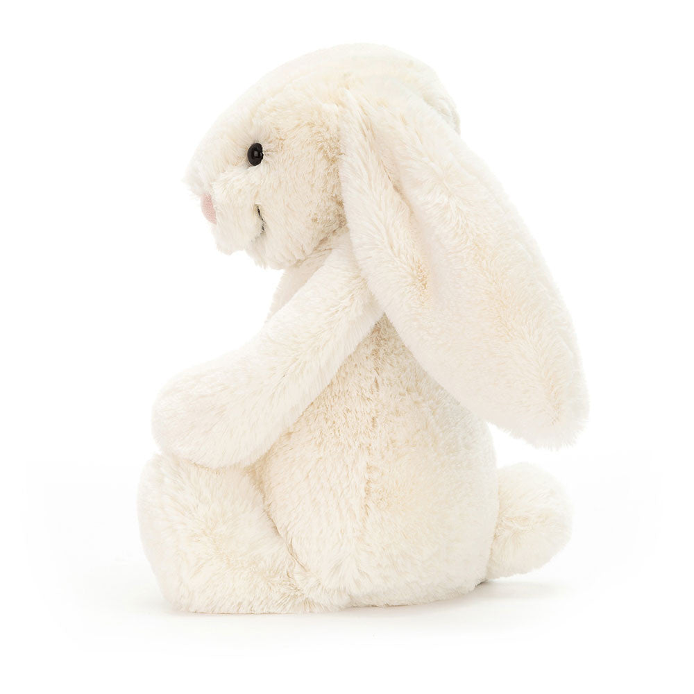 Side view of the cream Jellycat Bashful Bunny Original showing its long ears and soft profile