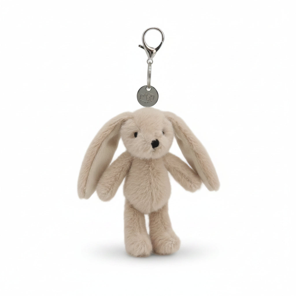 Beige bunny charm with long ears hanging from a metal lobster clasp