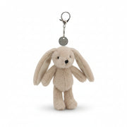 Beige bunny charm with long ears hanging from a metal lobster clasp