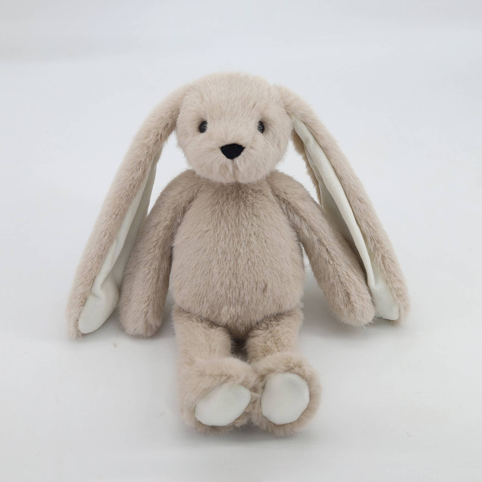 Beige plush bunny front view with long floppy ears and white paw pads