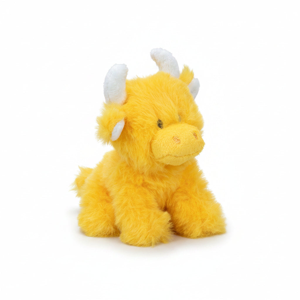Mini orange Highland cow soft toy side view with white horns on grey background