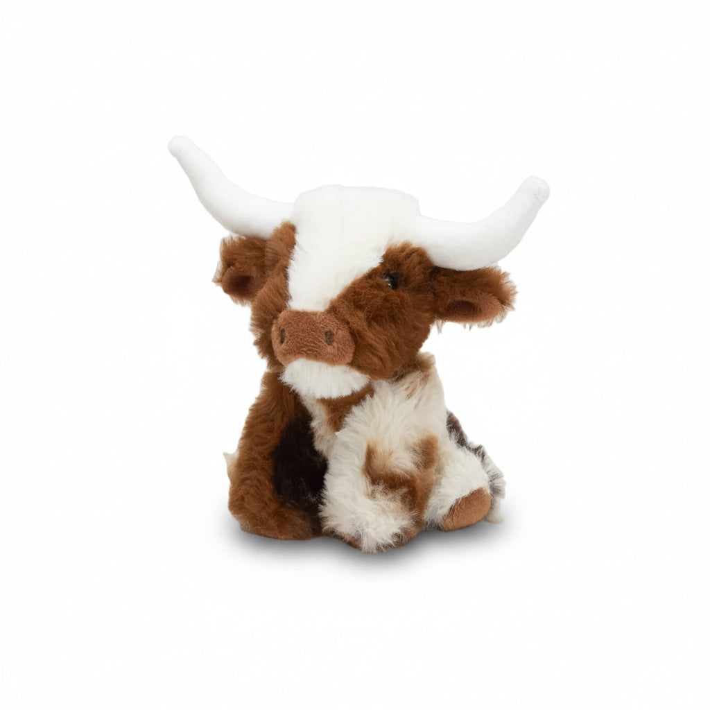 Texas Longhorn mini soft toy cow sitting with white horns on grey background