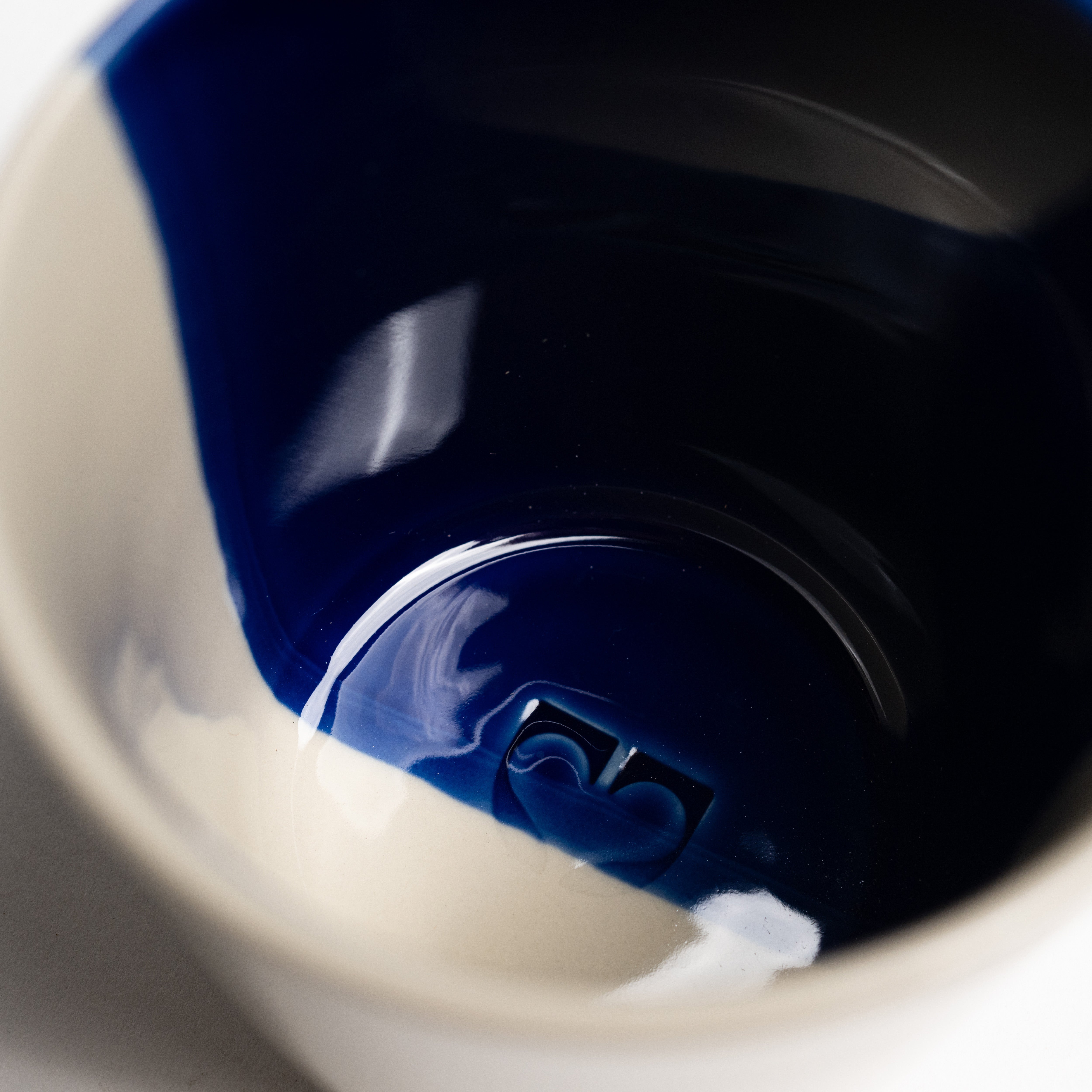 Close up inside an indigo blue Rue mug showing the glossy glaze