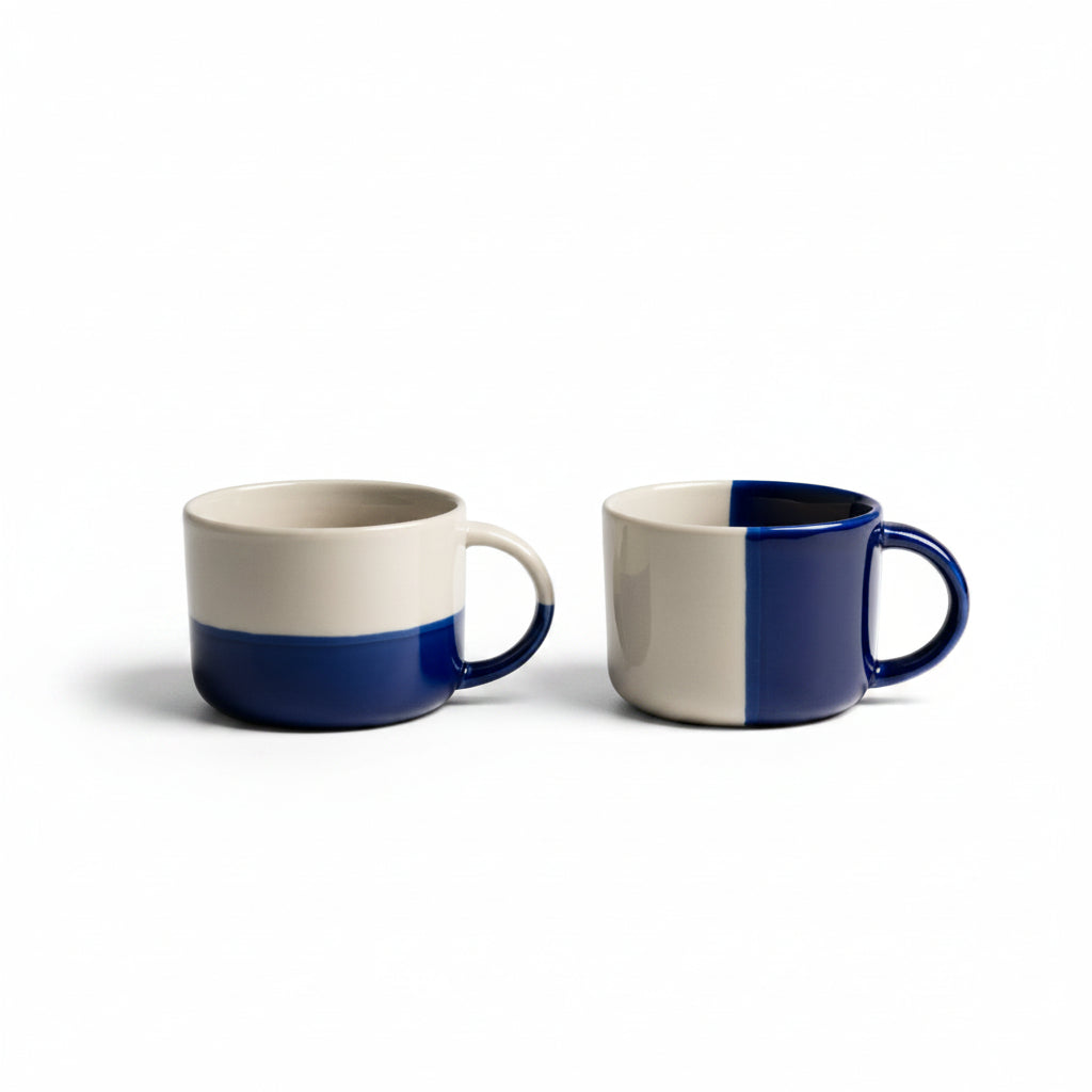 Two indigo blue dipped Rue mugs on a white background