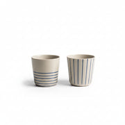 Two small indigo blue hand-etched Sorrel beakers on a white background