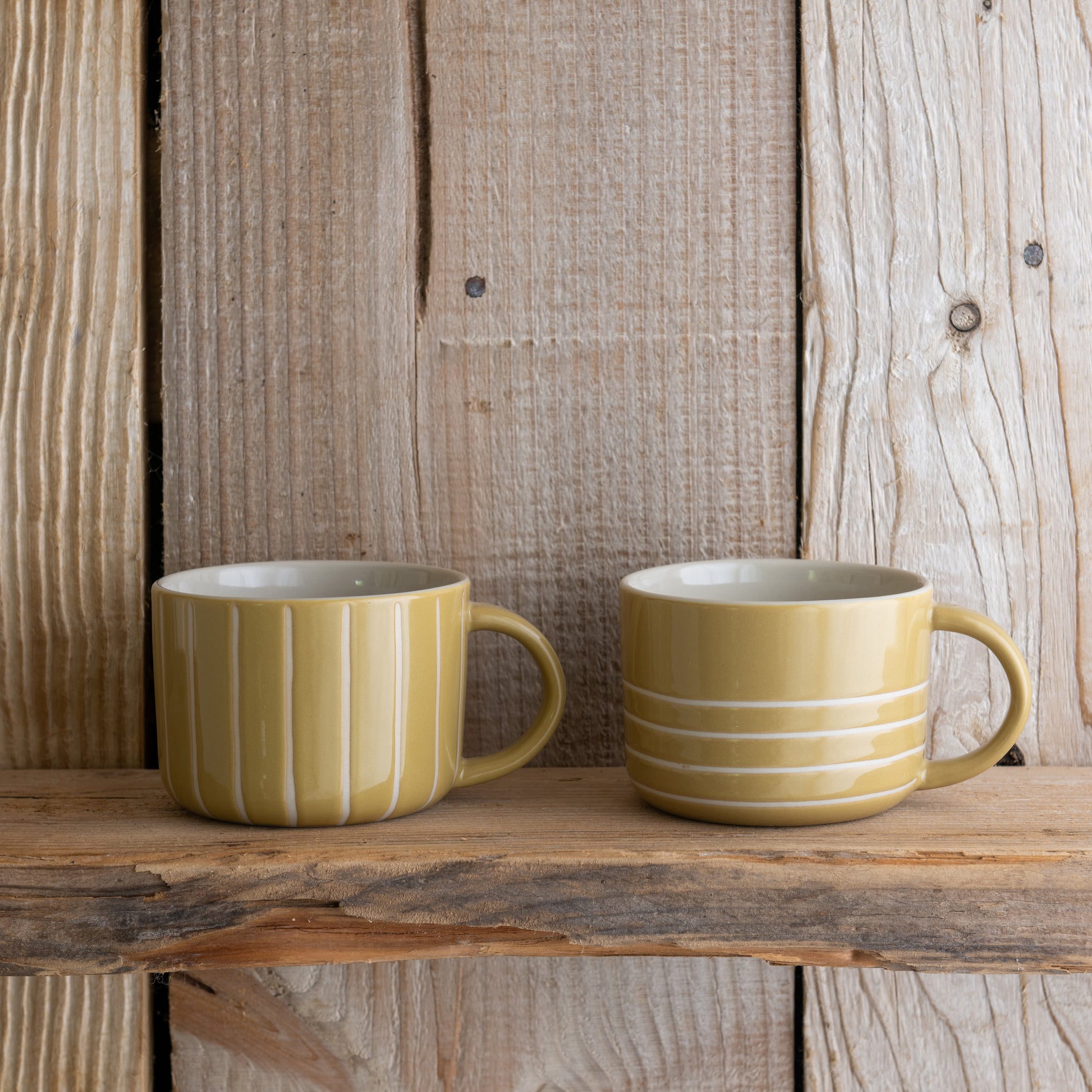Mustard yellow Vervain mugs on a rustic wooden shelf