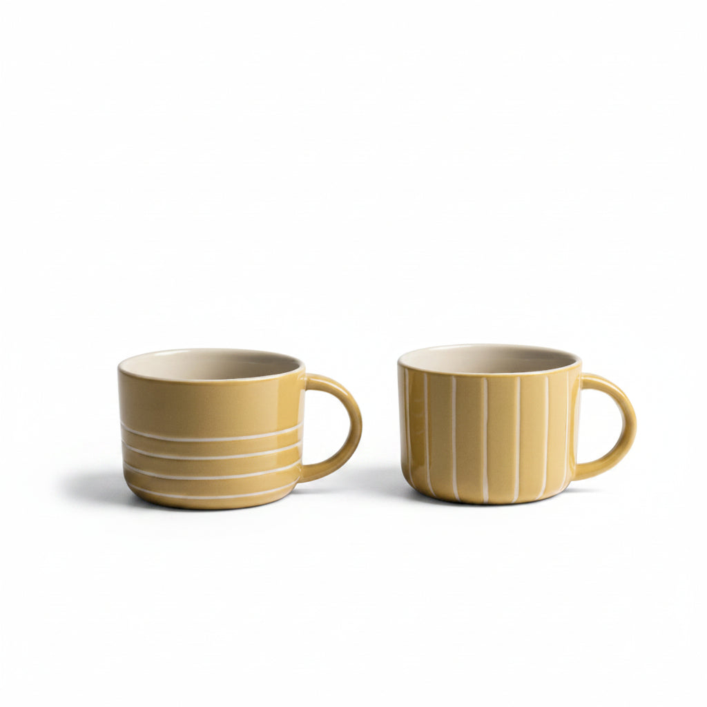 Two mustard yellow etched Vervain mugs on a white background