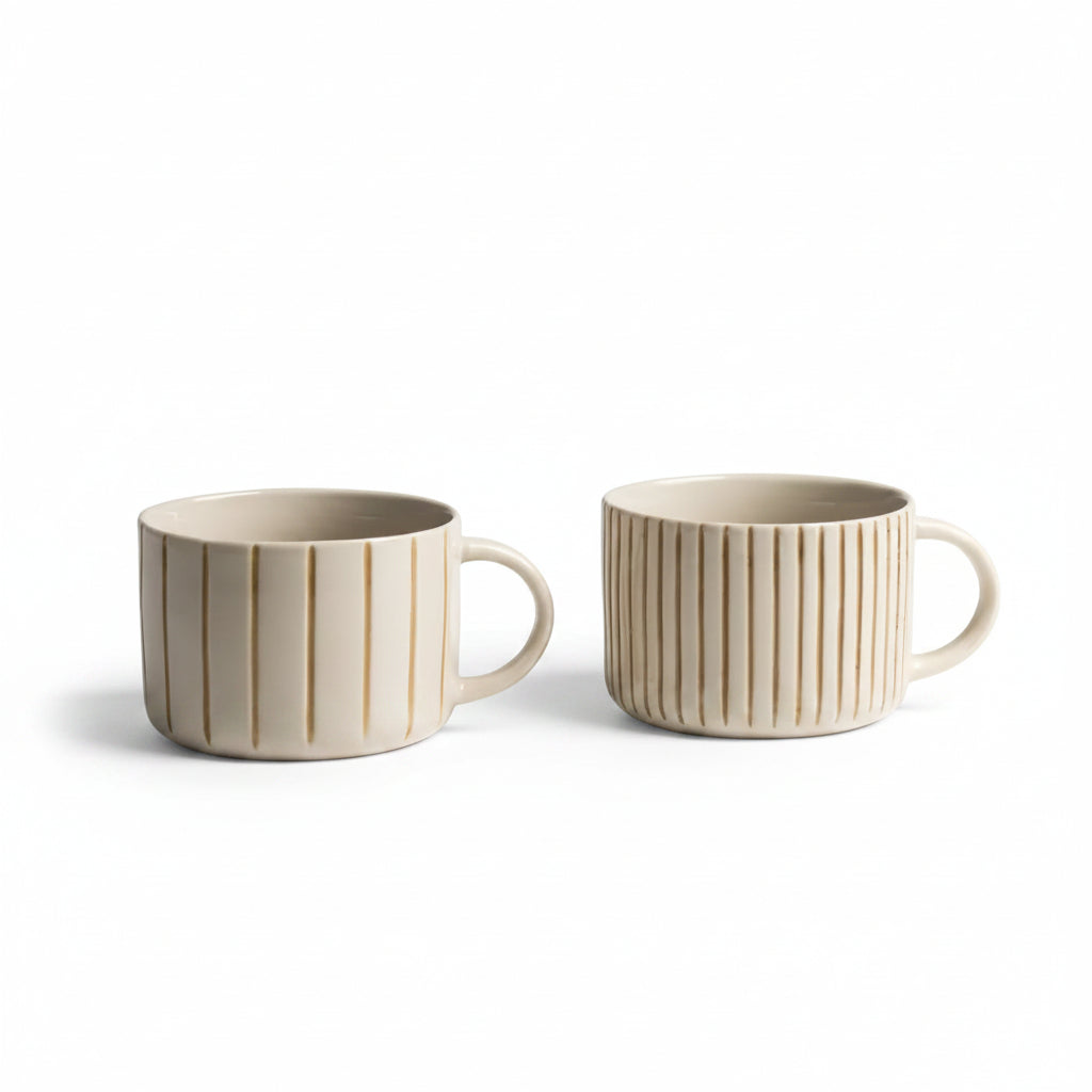 Pair of mustard yellow hand-etched Yarrow mugs on a white background