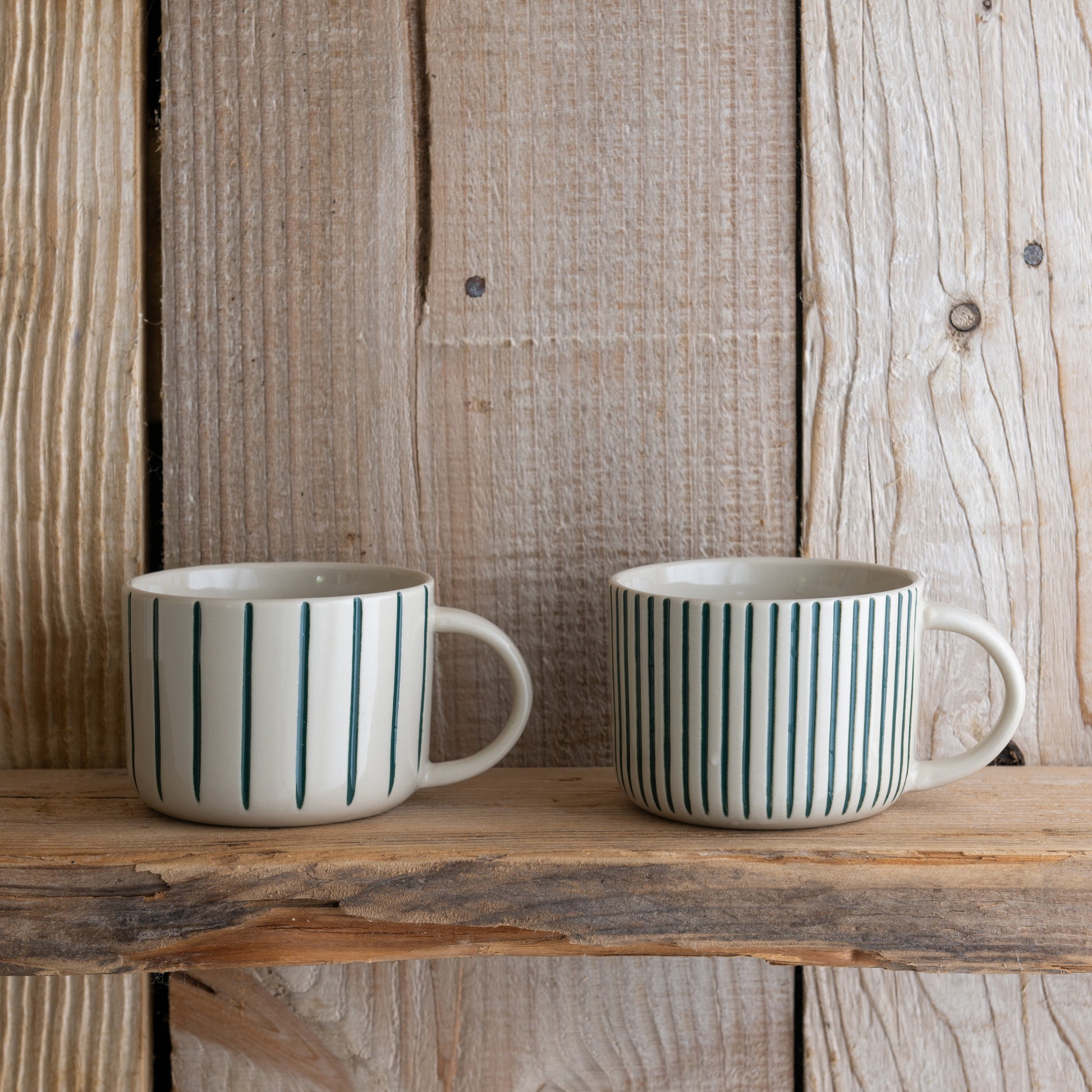 Sea green Yarrow mugs on a rustic wooden shelf