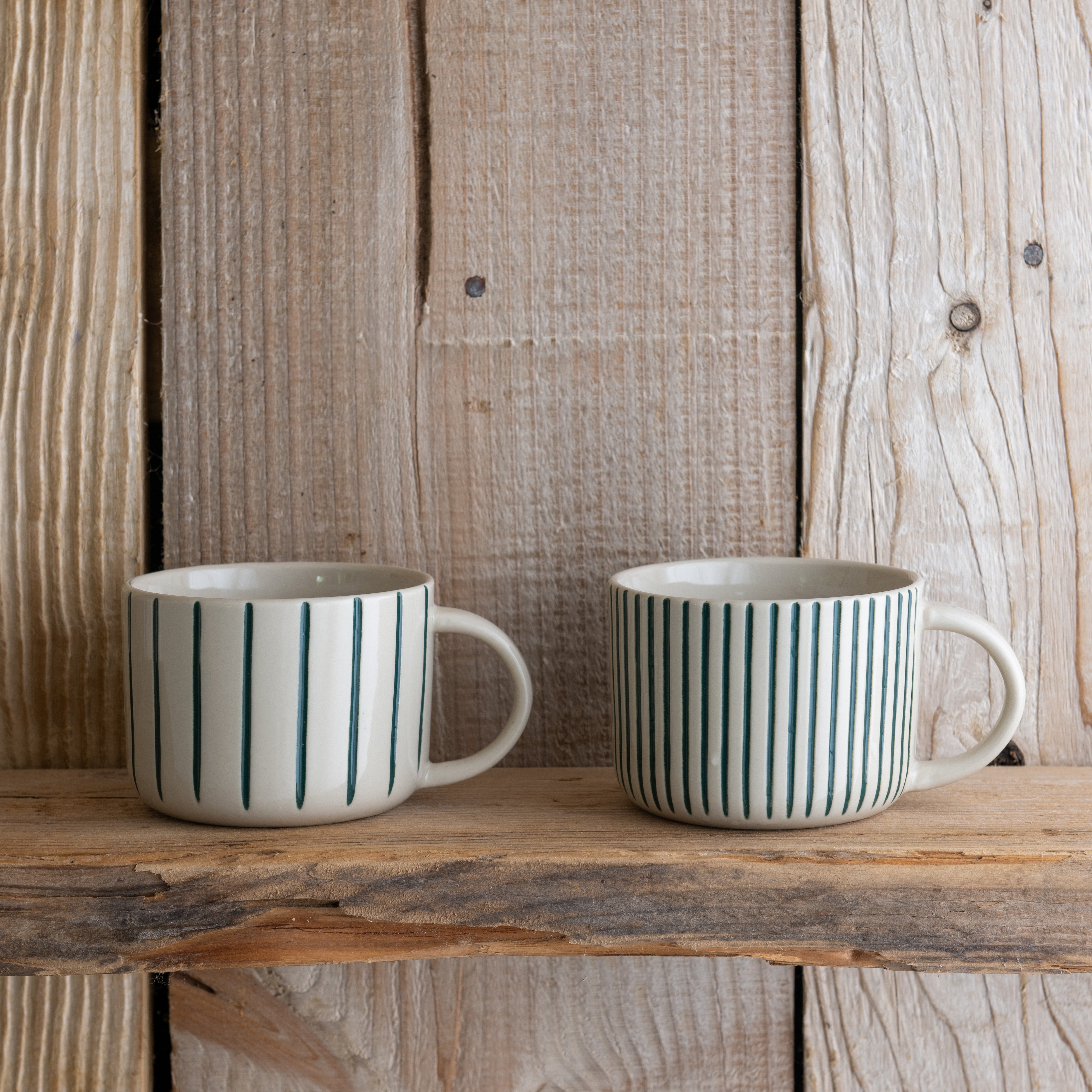 Sea green Yarrow mugs on a rustic wooden shelf