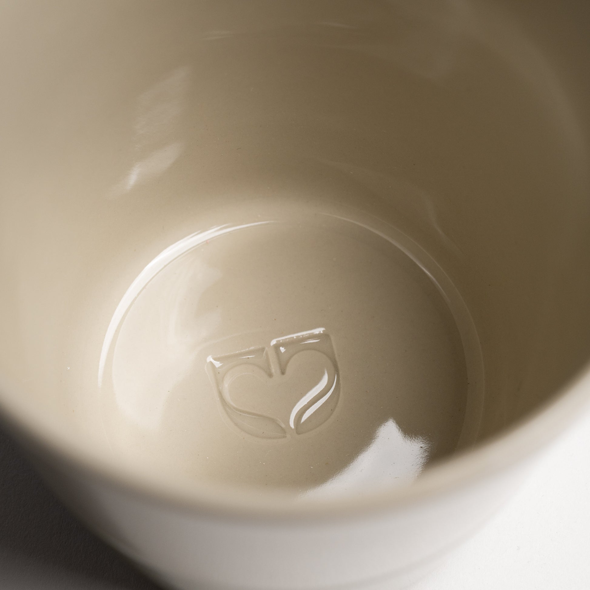 Close up of the Kindred icon embossed inside a Yarrow mug base