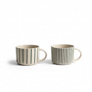 Two sea green hand-etched Yarrow mugs on a white background