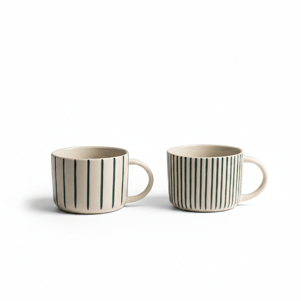 Two sea green hand-etched Yarrow mugs on a white background