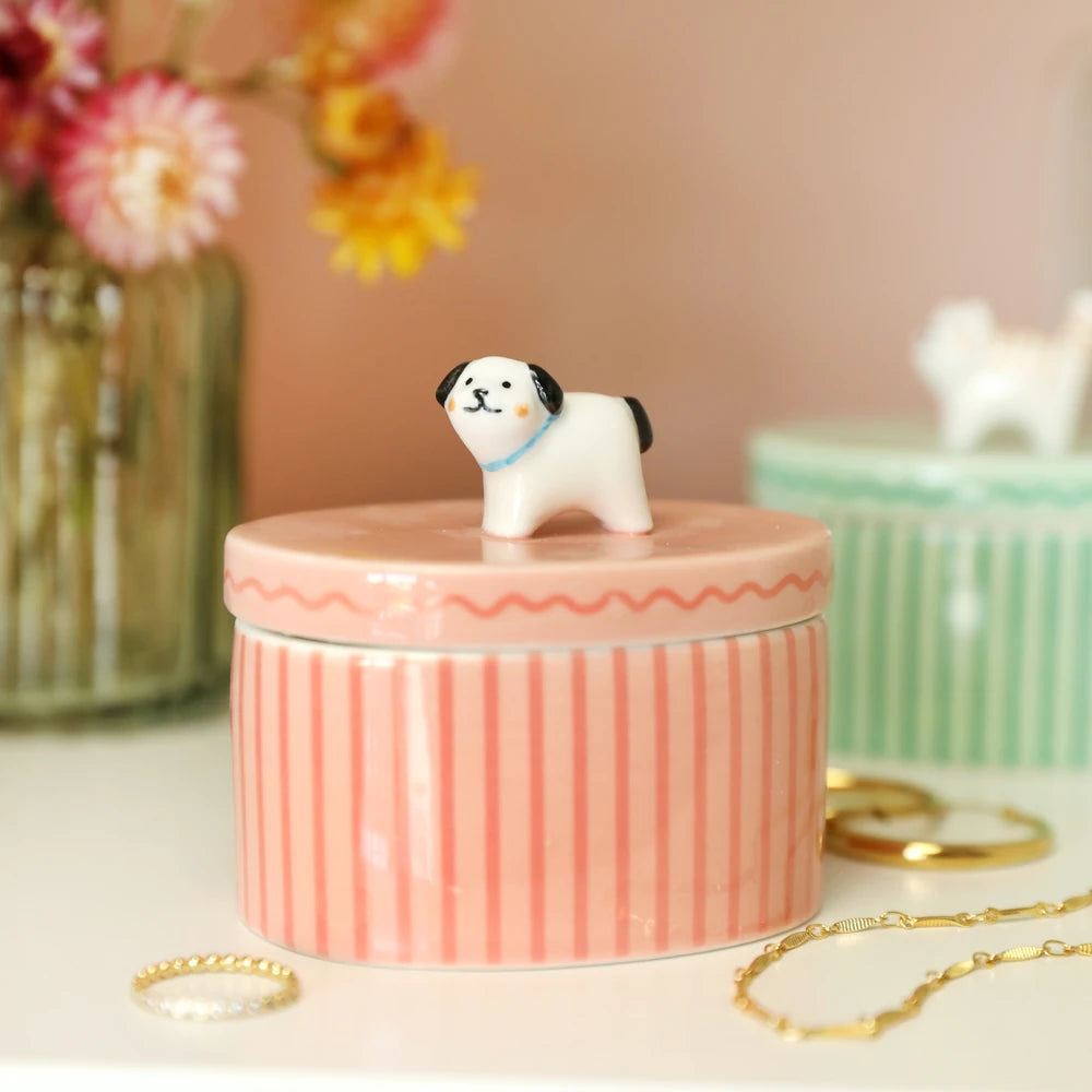 Pink dog trinket pot styled on a dresser beside dried flowers and jewellery