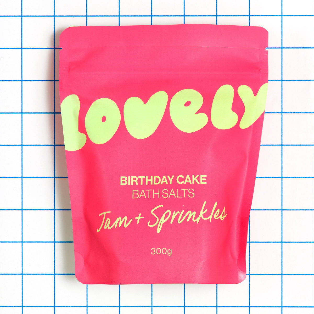 Birthday Cake bath salts pouch on a blue grid