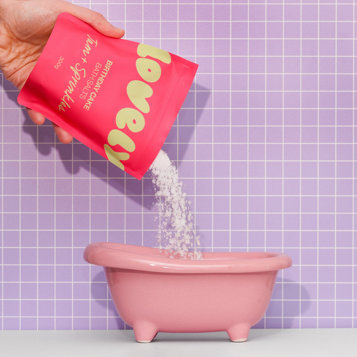 Birthday Cake bath salts pouring into a pink mini bath