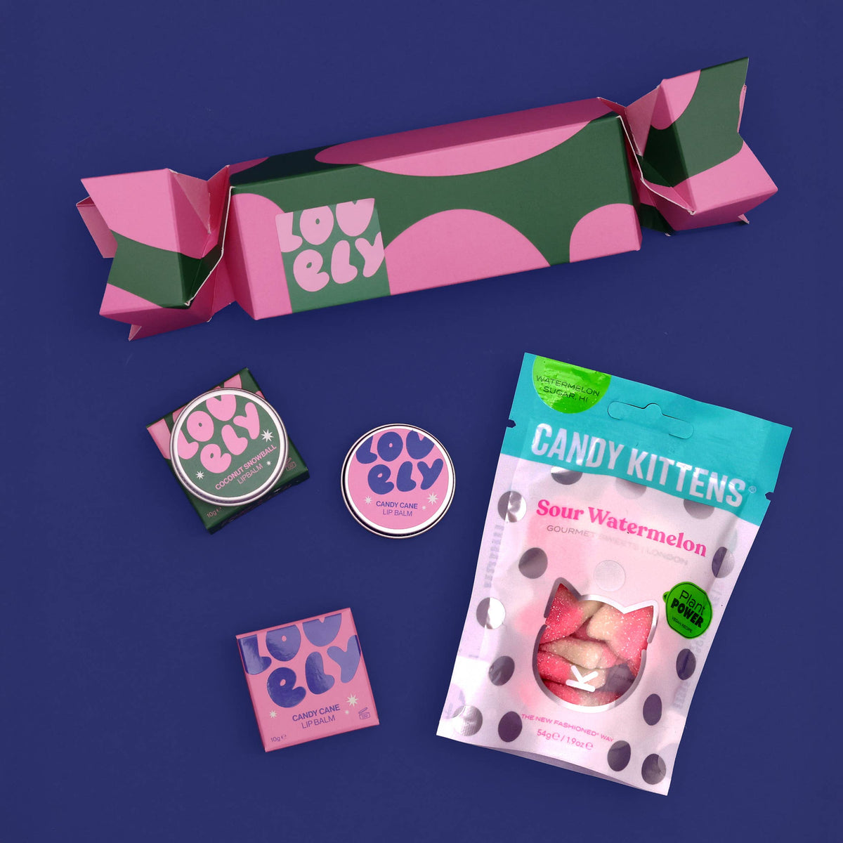 Christmas cracker with lip balms and Candy Kittens on navy
