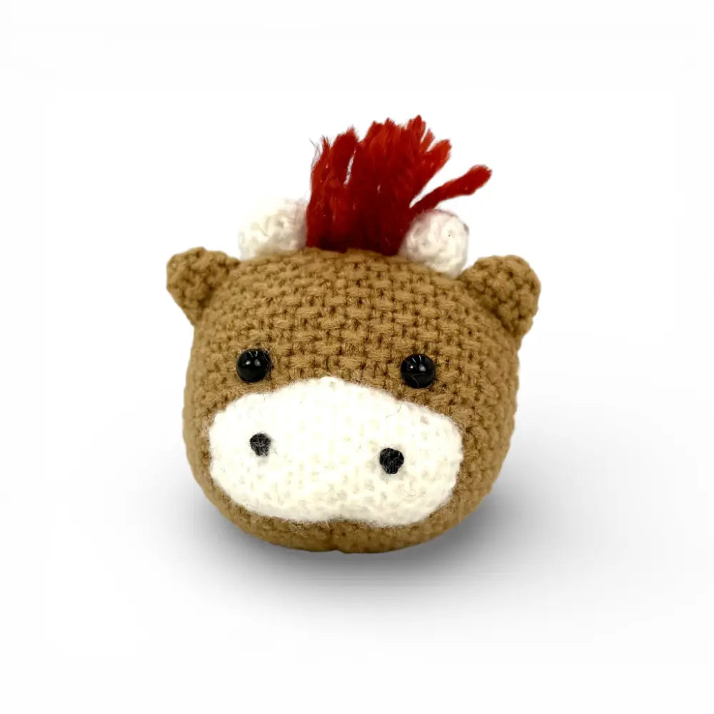 Hand-crocheted mini Highland cow keychain with ivory horns and ginger fringe