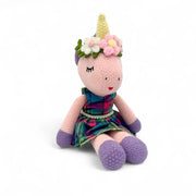 Hand-crocheted Annie unicorn doll in a tartan skirt with a flower crown