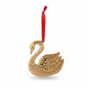 Gold aluminium swan decoration on red velvet ribbon hanging on a Christmas tree
