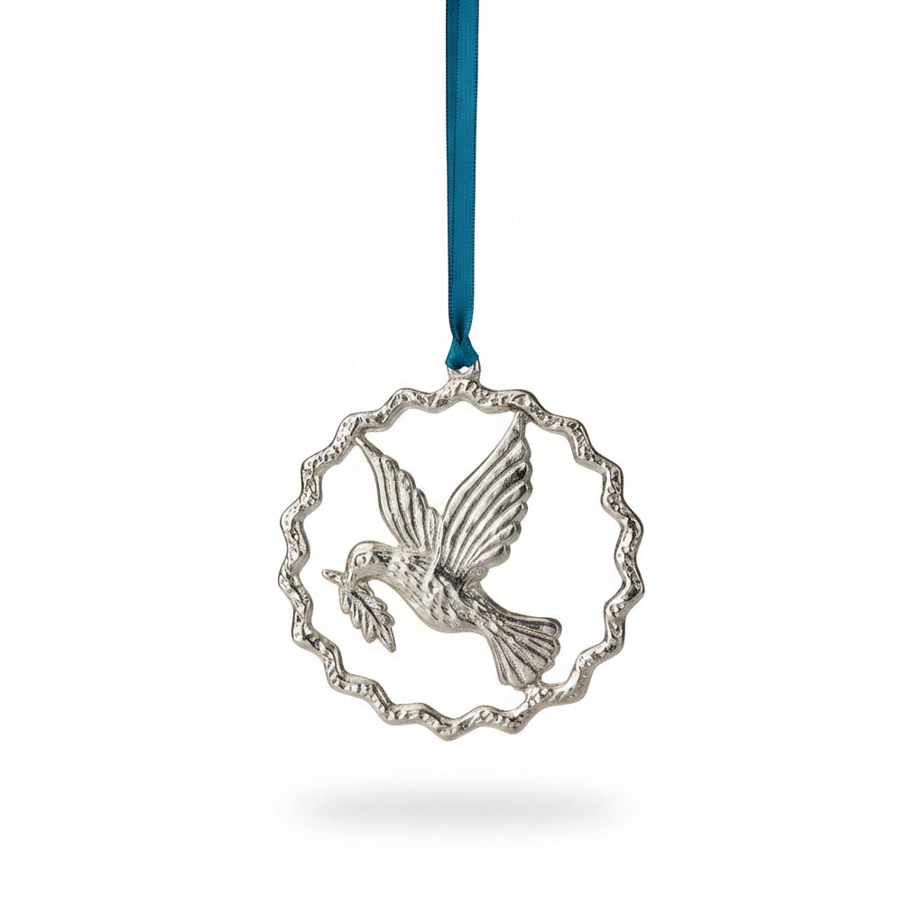 Silver aluminium peace dove in a rippled ring on blue velvet, hanging on a tree
