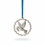 Silver aluminium peace dove in a rippled ring on blue velvet, hanging on a tree