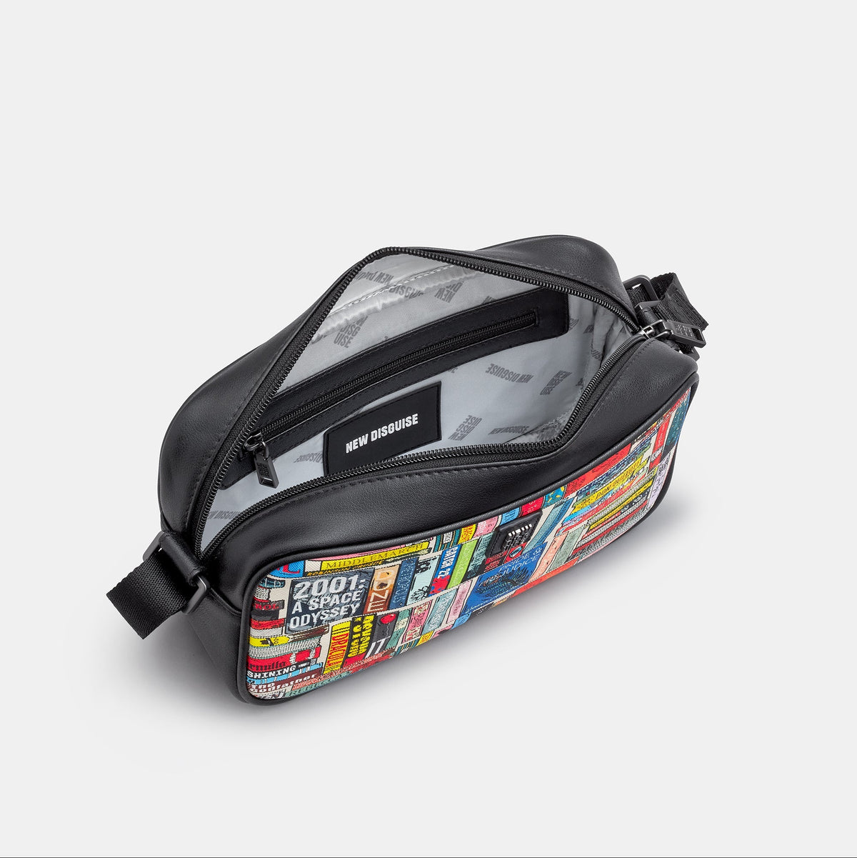 Classic Library Cross Body Bag in book spine print, black trim, angled view