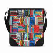 Classic Library Maxi Cross Body Bag in book spine print, black trim, front view on grey