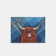 Highland cow card holder in blue tweed-effect vegan leather, front view on grey