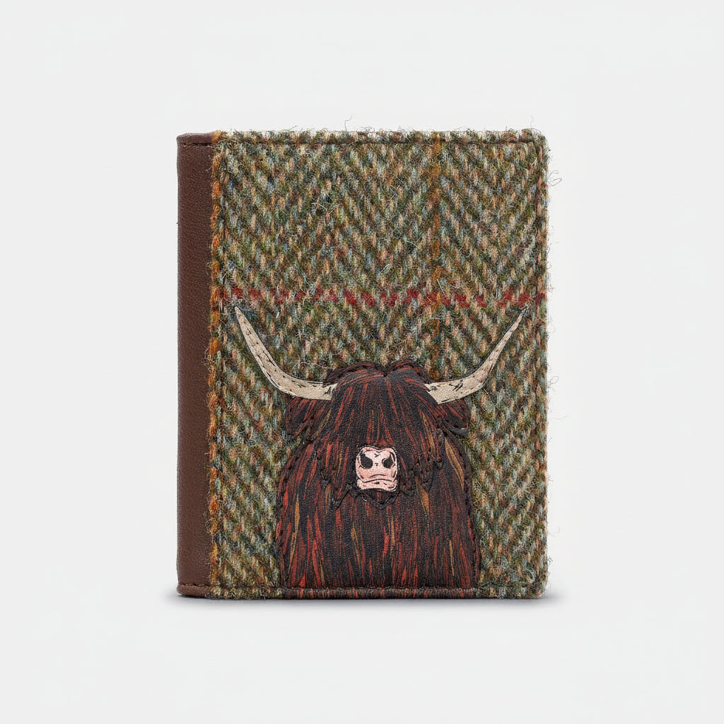 Highland cow flap-over card holder in green tweed-effect vegan leather, front view on grey