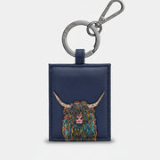 Navy leather key fob with a colorful highland cow design on a white background