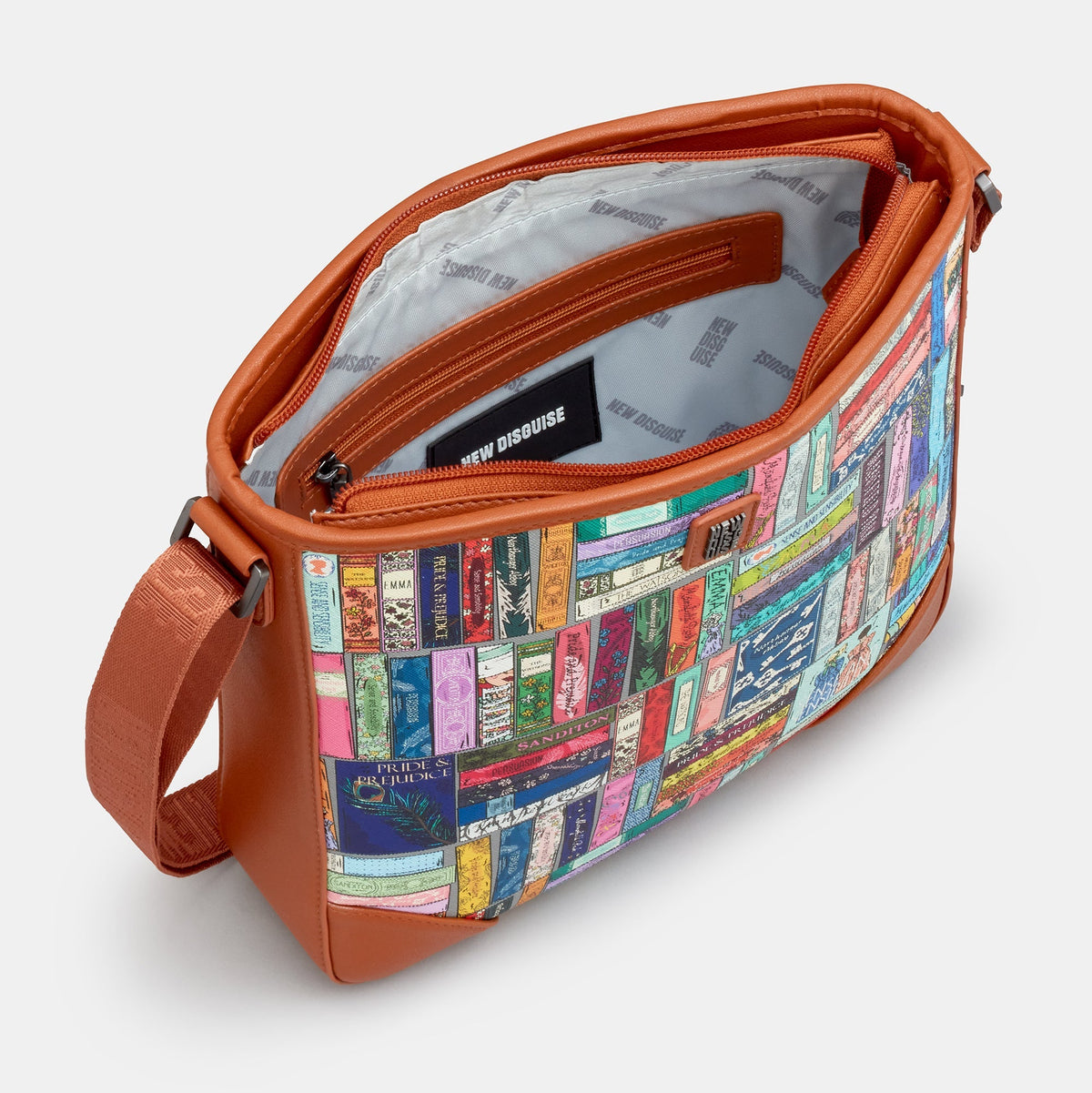Jane Austen Library Maxi Cross Body Bag in book spine print, tan trim, angled view