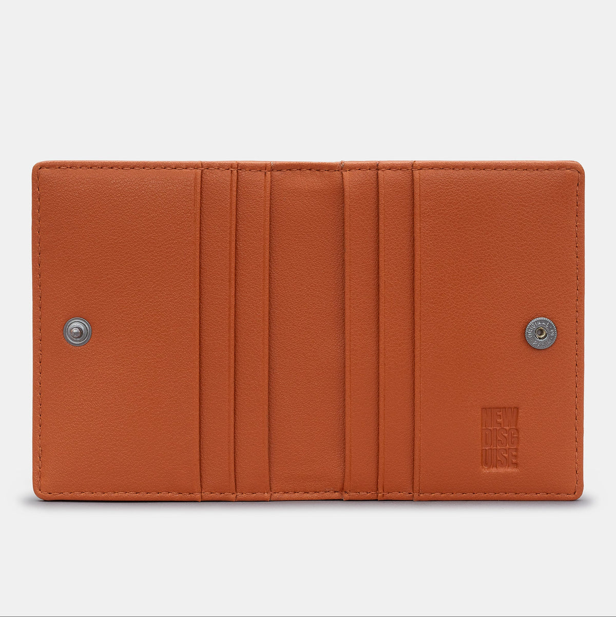 Nolan Card Holder in navy and tan, open, showing the card slots