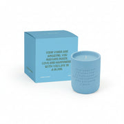 Blue cement candle with matching blue gift box on white