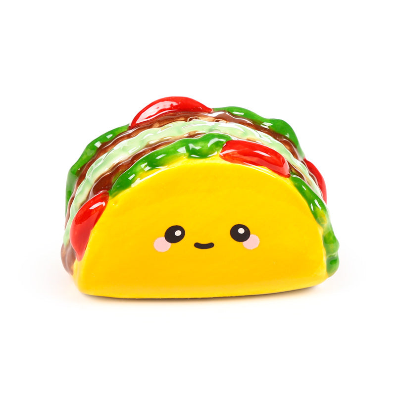 Smiling ceramic taco shaker filled with painted lettuce and tomato