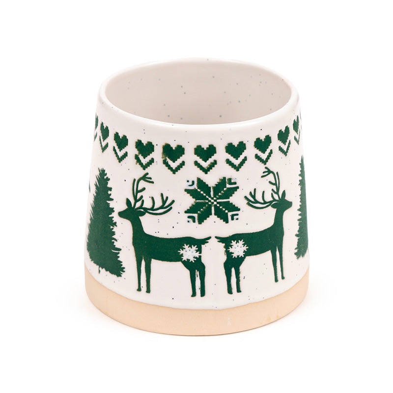 Close view of the green reindeer and folk flower pattern on the mug