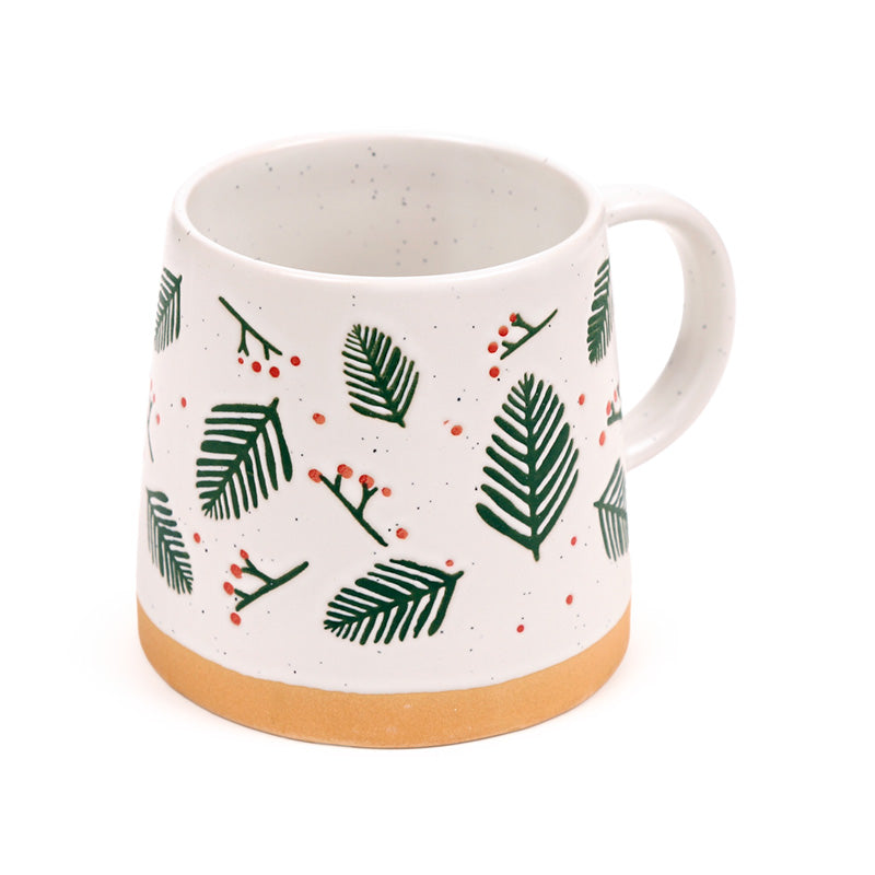 Pine sprigs stoneware mug at an angle showing the bare clay foot