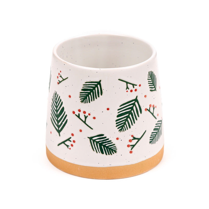Close view of the printed pine sprig and berry pattern on the mug
