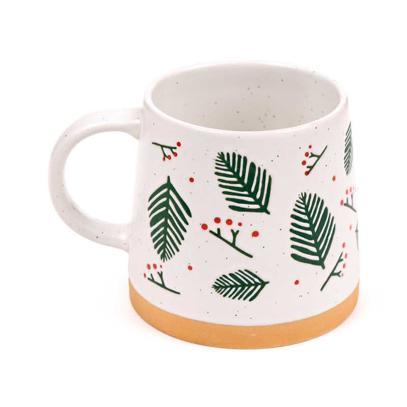 Pine sprigs stoneware mug with the handle to the left on white