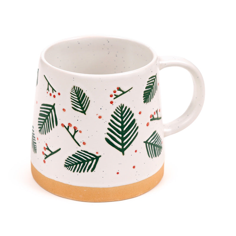 Cream stoneware mug printed with green pine sprigs and red berries