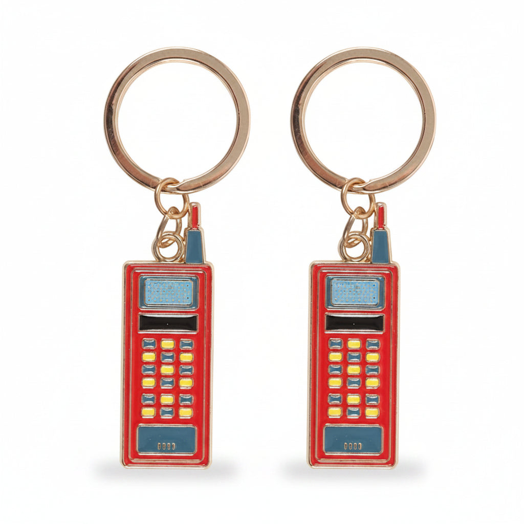Two red enamel walkie talkie keyrings side by side on white background