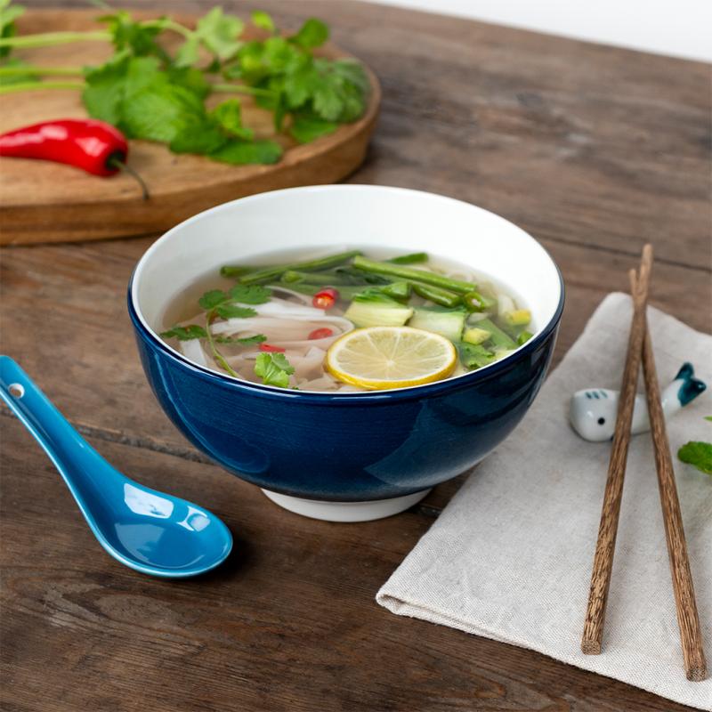 Ceramic noodle bowl set with blue whale design displayed